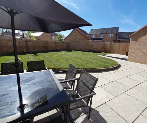 Raised lawn area and large patio area
